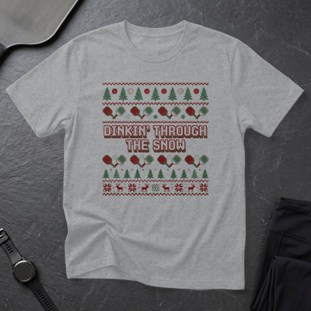 Grey t-shirt with a Christmas-themed ugly sweater pattern and "Dinkin' Through The Snow" text.