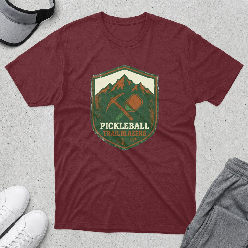 Maroon t-shirt with "Pickleball Trailblazers" shield logo featuring mountains, a pickaxe, and a paddle.