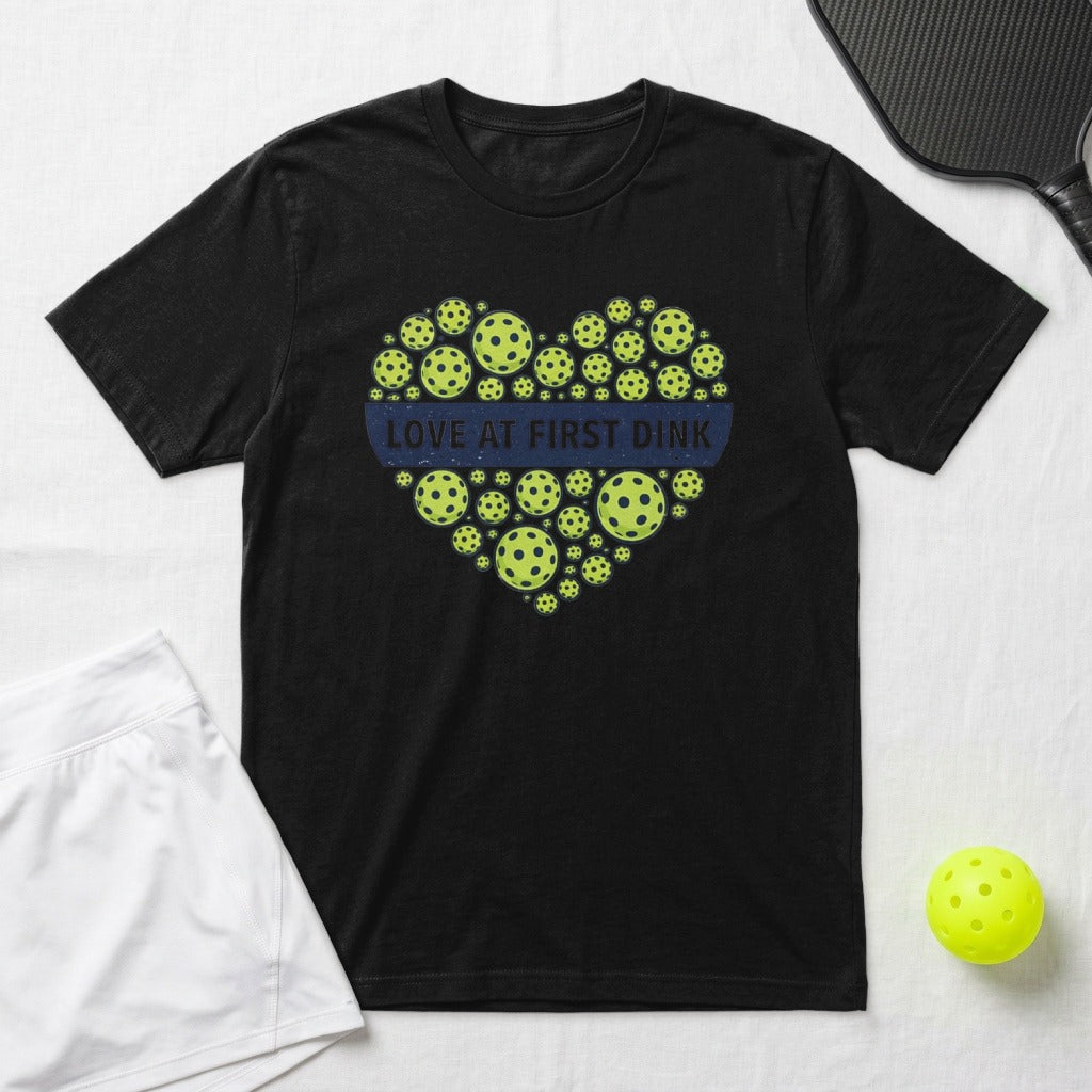 Black t-shirt with a heart of pickleballs and "Love at First Dink" text.