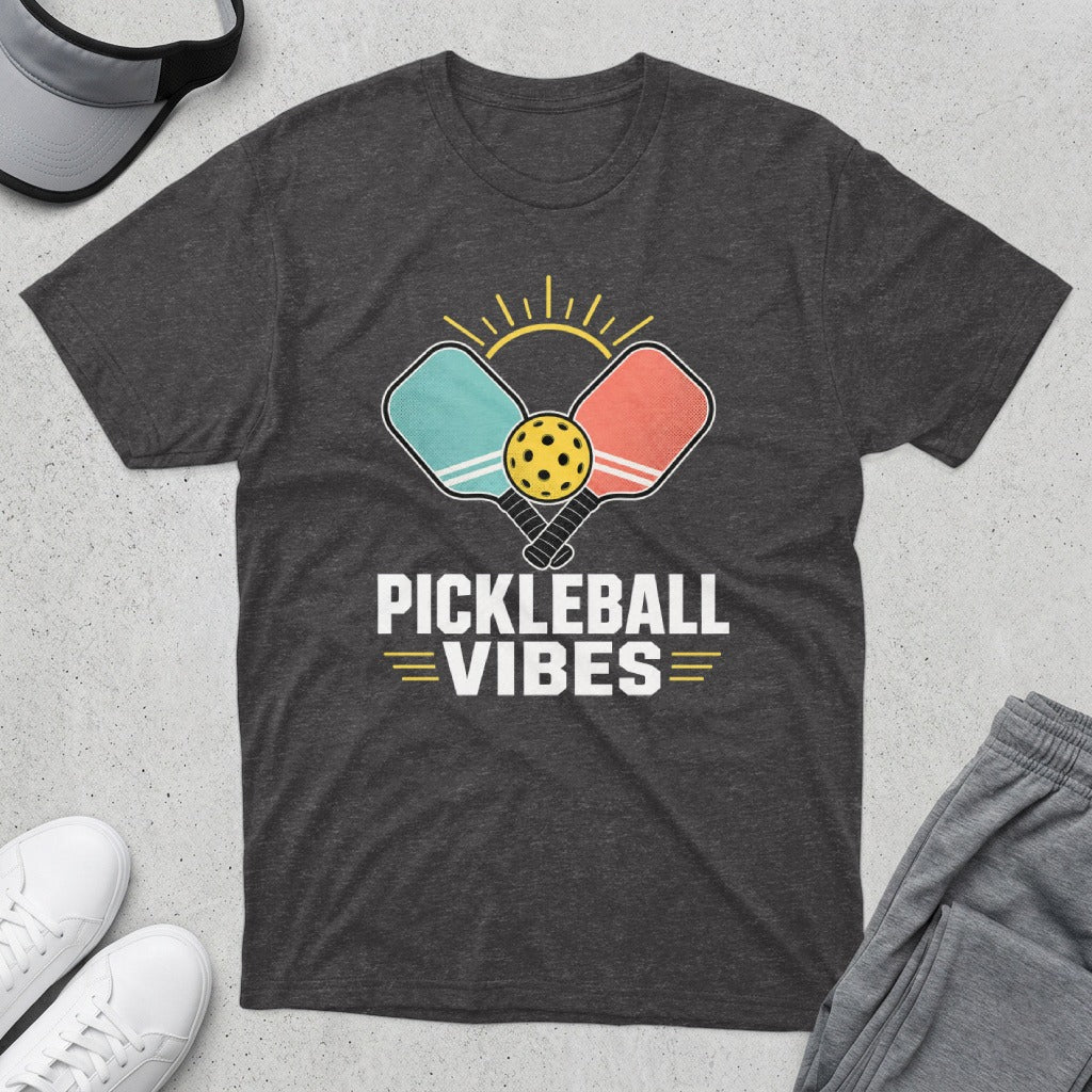 Dark gray t-shirt with pickleball paddles, ball, and sun graphic and "PICKLEBALL VIBES" text.