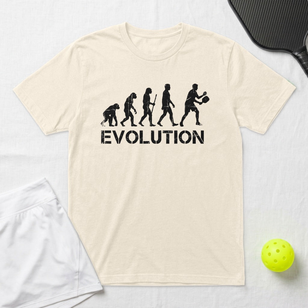 T-shirt with a graphic depicting human evolution ending with a person playing pickleball.