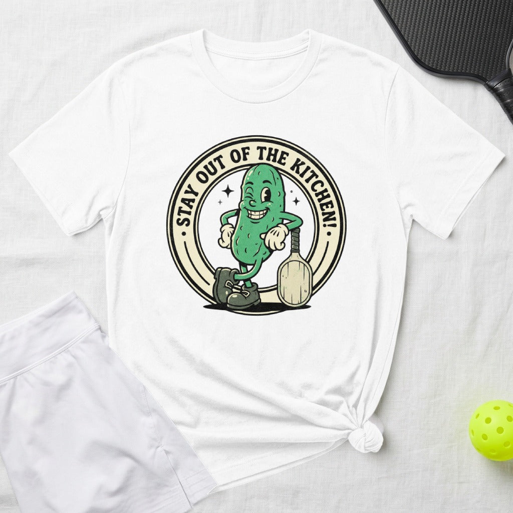 Cartoon pickle wearing sunglasses and holding a pickleball paddle.
