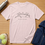 Light pink t-shirt with minimalist line art of two tennis players and "THE ART OF THE GAME" text.