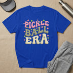 Blue t-shirt with "PICKLE BALL ERA" in colorful, retro bubble letters.