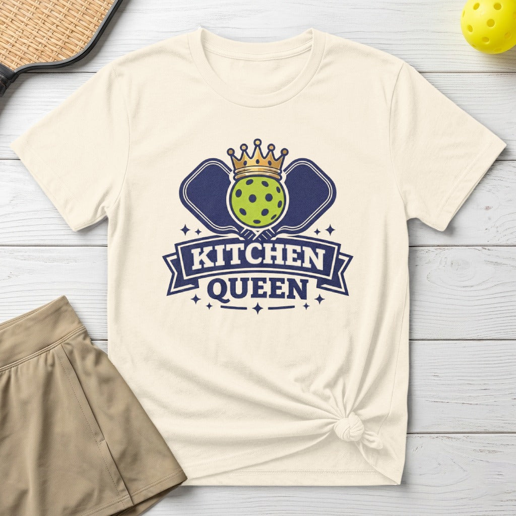 Pickleball graphic with "Kitchen Queen" text, crown, and paddles on a cream t-shirt.