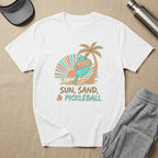 White t-shirt with "Sun, Sand, & Pickleball" text and beach graphic.