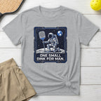Astronaut on moon holding pickleball paddle, "One small dink for man."