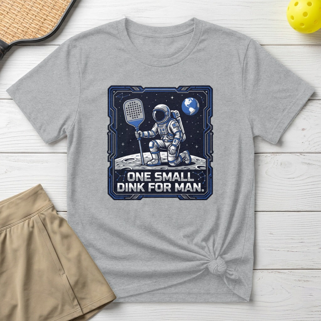Astronaut on moon holding pickleball paddle, "One small dink for man."