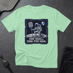 Astronaut on moon holding pickleball paddle, text reads "ONE SMALL DINK FOR MAN."