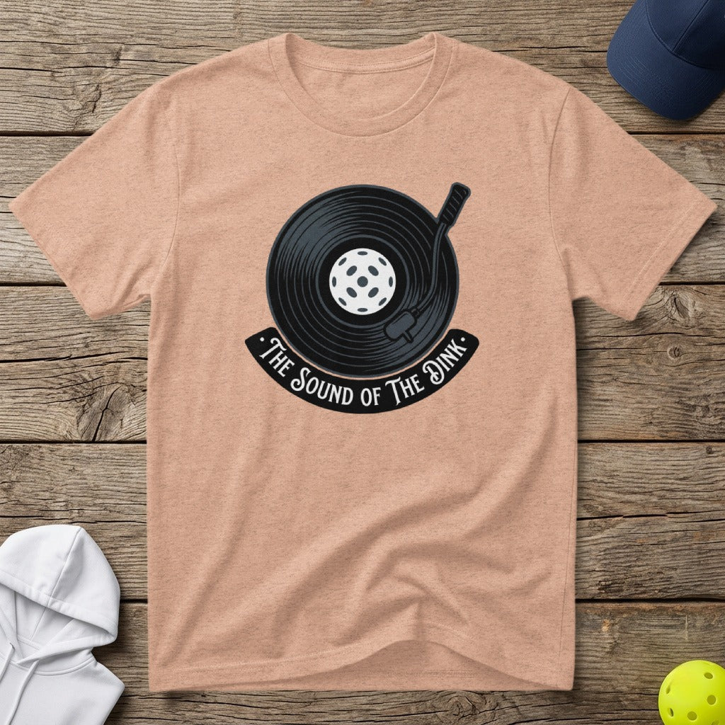 Peach t-shirt with a vinyl record and pickleball graphic, reads "The Sound of the Dink".