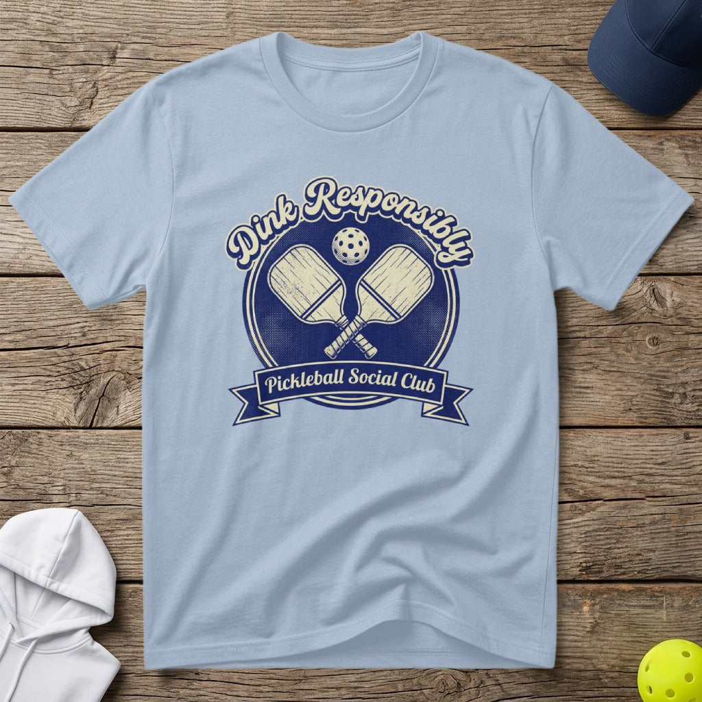 Light blue t-shirt with "Dink Responsibly Pickleball Social Club" text and crossed paddles.