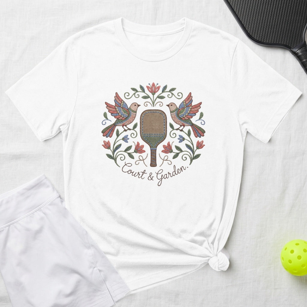 White t-shirt with embroidered floral and bird design, "Court & Garden" text.
