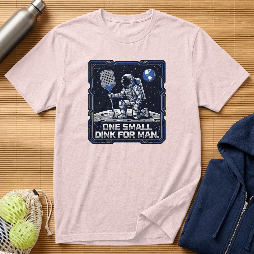 T-shirt with astronaut playing pickleball on the moon, text "ONE SMALL DINK FOR MAN."