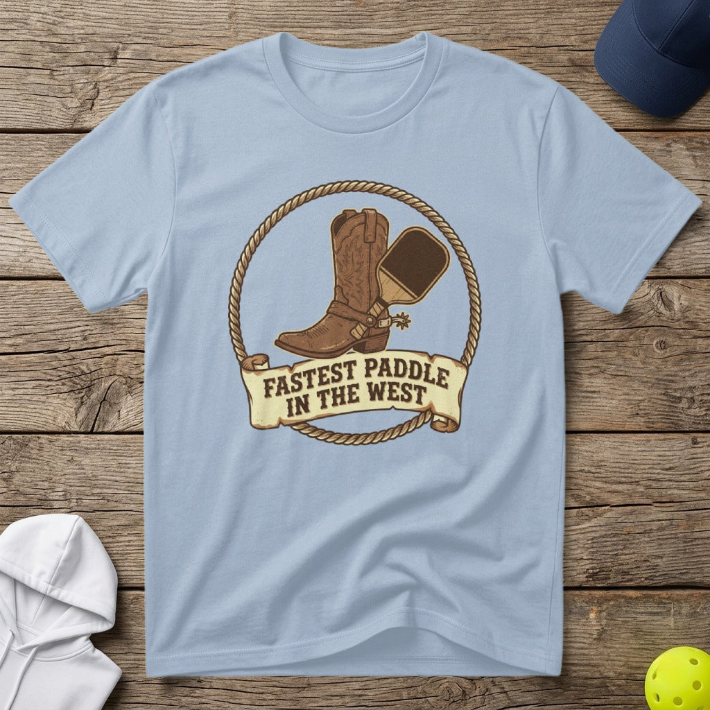 Light blue t-shirt with cowboy boot, paddle, and "Fastest Paddle in the West" text.