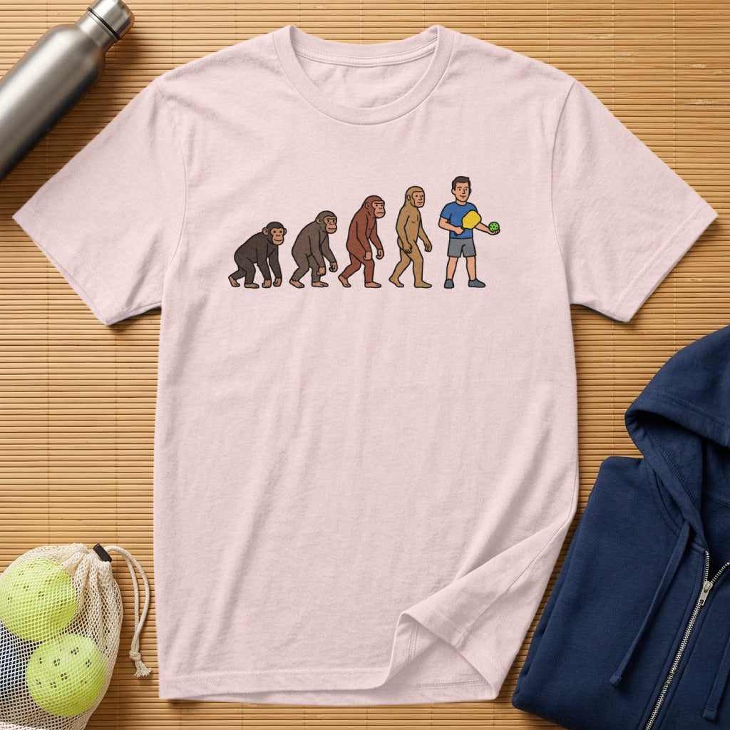 T-shirt graphic showing human evolution ending with a pickleball player.