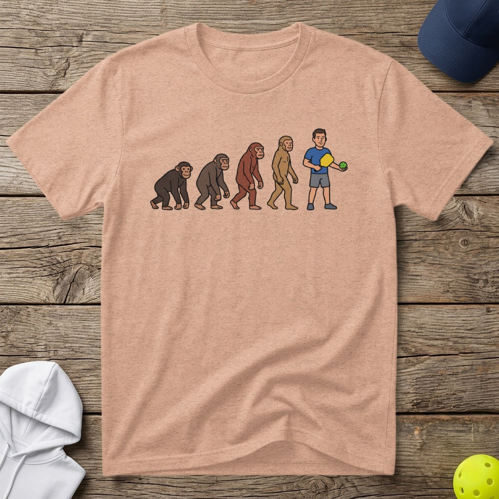 T-shirt with cartoon evolution of man to pickleball player.