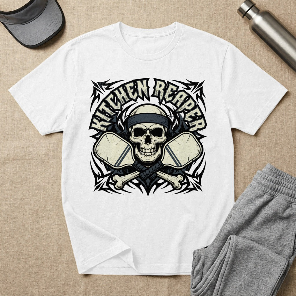 White t-shirt with skull, crossed pickleball paddles, and "Kitchen Reaper" text.