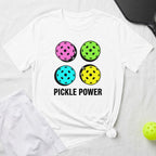 White t-shirt with four colorful pickleballs and "PICKLE POWER" text.