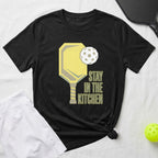 Black t-shirt with yellow pickleball paddle, ball, and "Stay in the Kitchen" text.