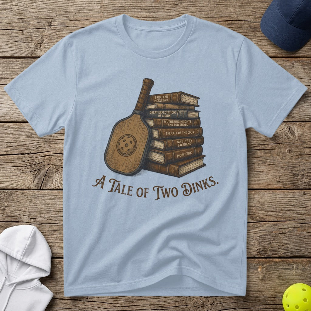 T-shirt with books, pickleball paddle, and "A Tale of Two Dinks" text.