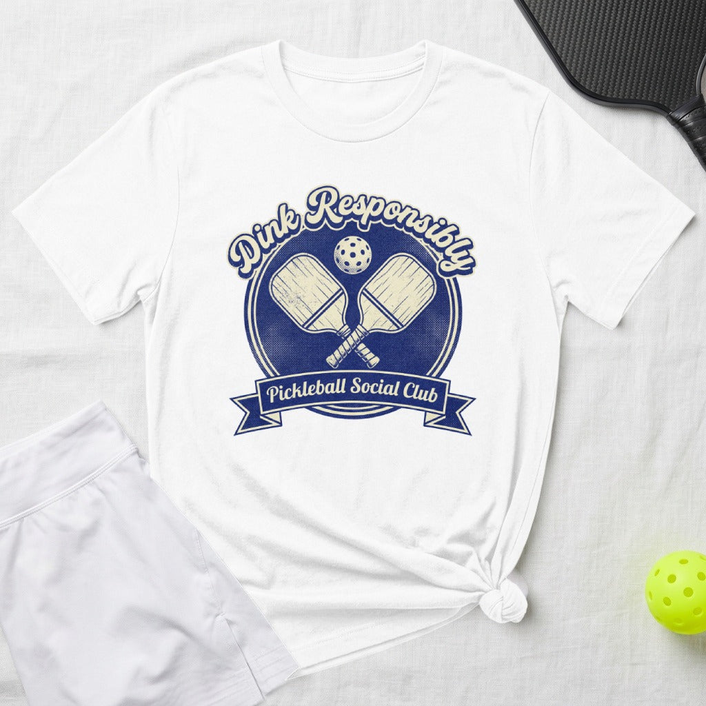 White t-shirt with blue circle logo for "Dink Responsibly Pickleball Social Club".