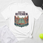 White t-shirt with graphic of pickleball court in desert landscape.