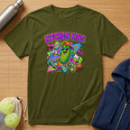 Green t-shirt featuring a cartoon pickle playing pickleball with graffiti background.