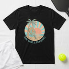 Black t-shirt with "Sun, Sand, & Pickleball" graphic featuring a paddle and palm tree.