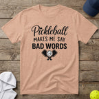 Peach t-shirt with "Pickleball Makes Me Say Bad Words" and crossed paddles.