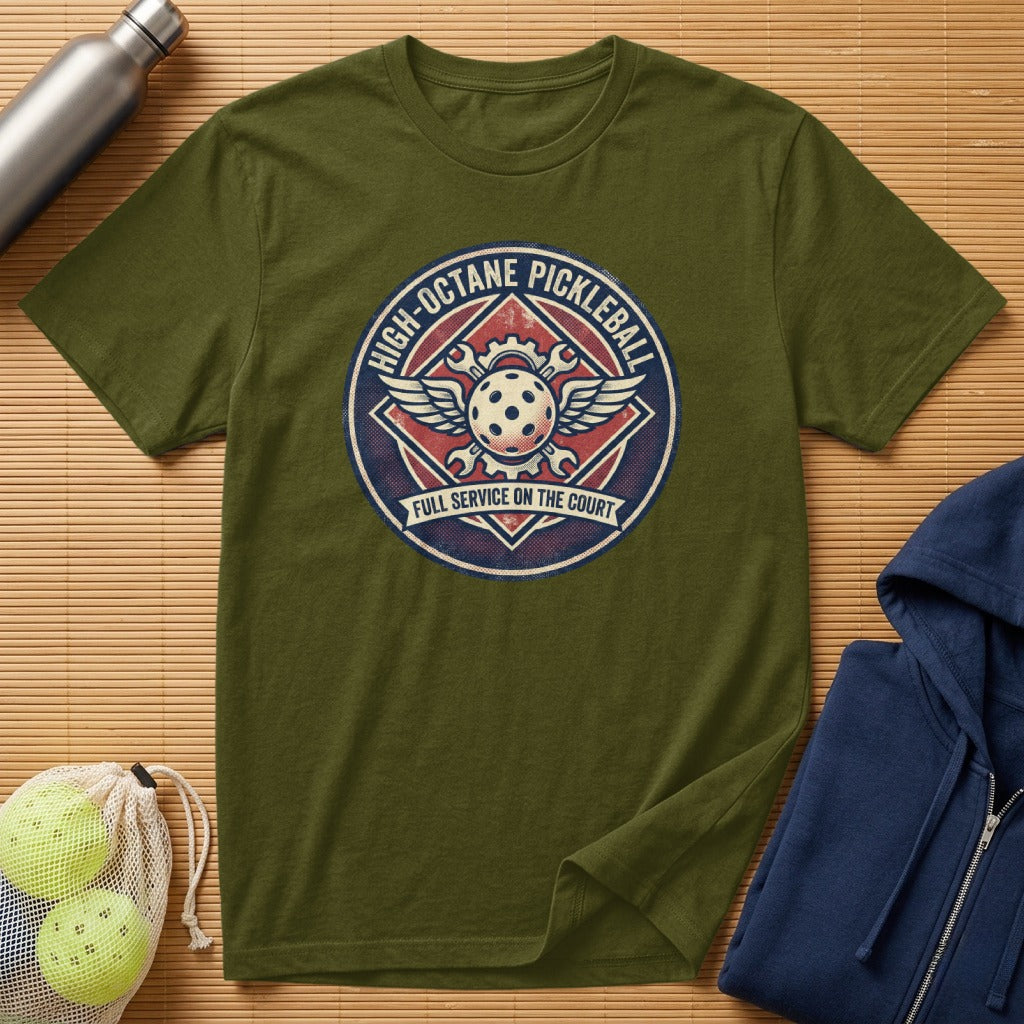 Olive green t-shirt with a circular pickleball logo featuring wings and text.