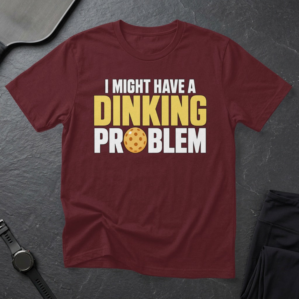 Maroon t-shirt with "I Might Have a Dinking Problem" and pickleball graphic.