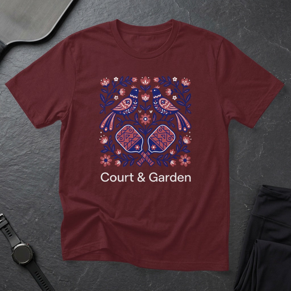 Maroon t-shirt with colorful bird and pickleball paddle floral design.