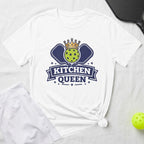 White t-shirt with "KITCHEN QUEEN" and pickleball graphic, alongside shorts and ball.