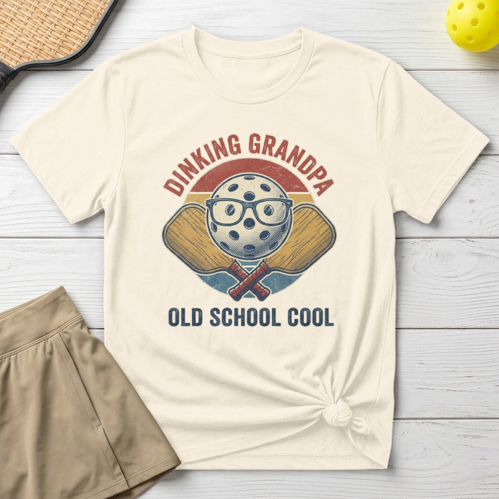 Pickleball t-shirt with "Dinking Grandpa Old School Cool" text and crossed paddles graphic.