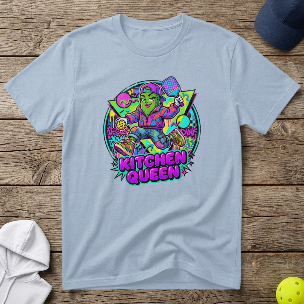 Pickleball player cartoon with "Kitchen Queen" text on a light blue t-shirt.