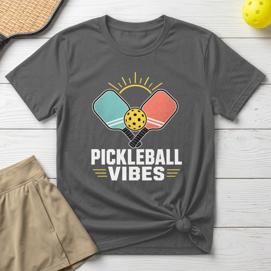 Pickleball Vibes t-shirt with crossed paddles and ball graphic over sunkissed lines.