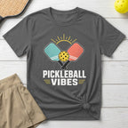 Pickleball Vibes t-shirt with crossed paddles and ball graphic over sunkissed lines.