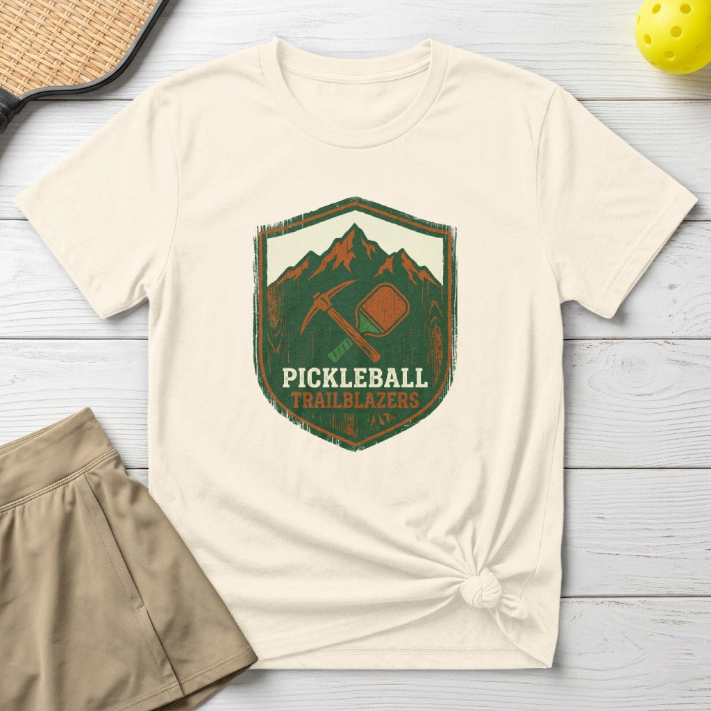 Cream t-shirt with "Pickleball Trailblazers" emblem featuring a paddle and pickaxe.