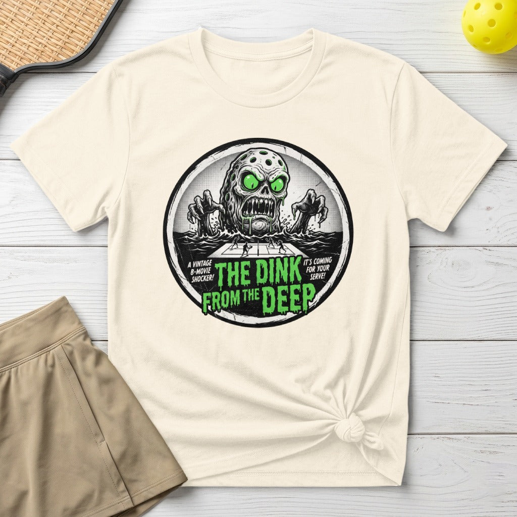 T-shirt graphic with a monster emerging from water, text "The Dink From The Deep".