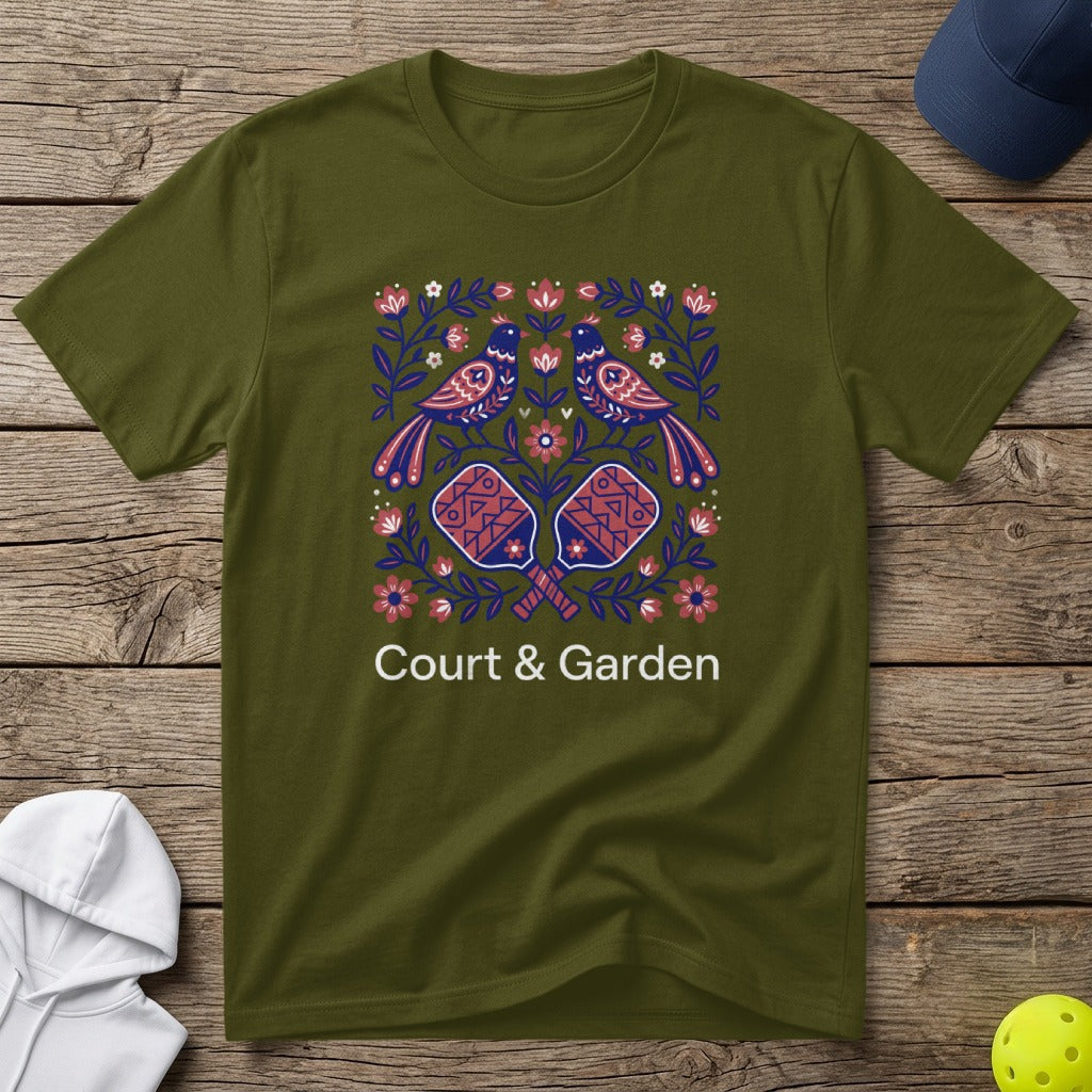 Olive green t-shirt with folk art birds, paddles, and flowers, reading "Court & Garden."