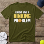 Olive t-shirt with "I MIGHT HAVE A DINKING PROBLEM" and pickleball graphic.