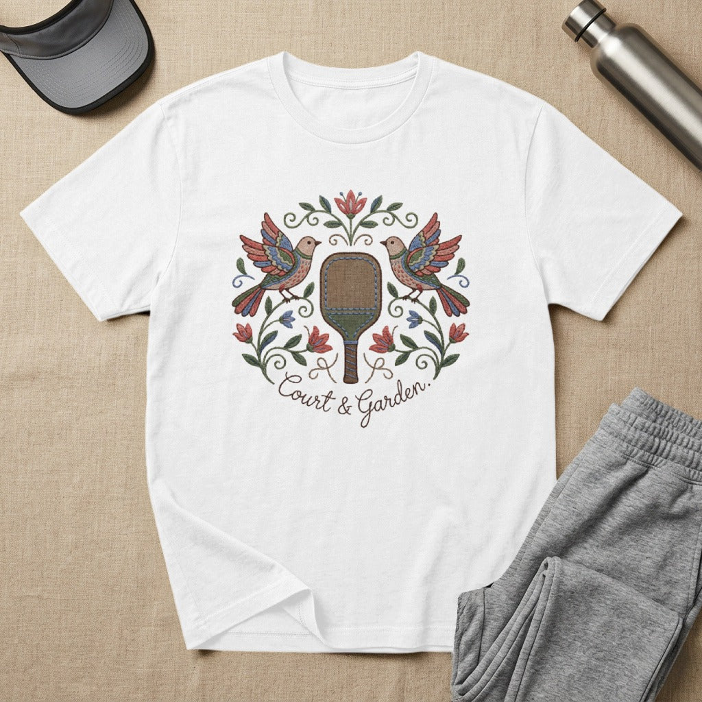 White t-shirt with embroidered birds, paddle, and "Court & Garden" text.
