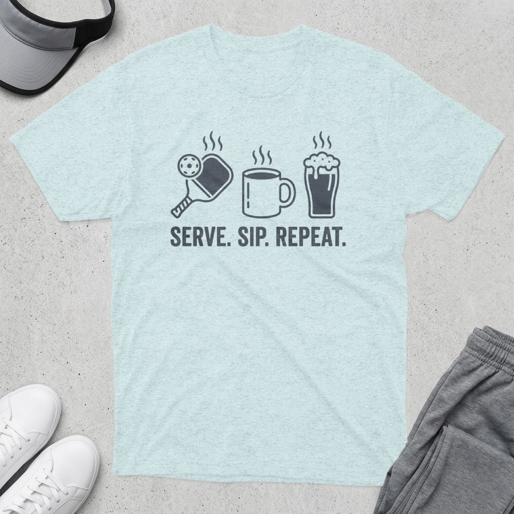 Light blue t-shirt with pickleball, coffee, and repeat icons, and text "SERVE. SIP. REPEAT."
