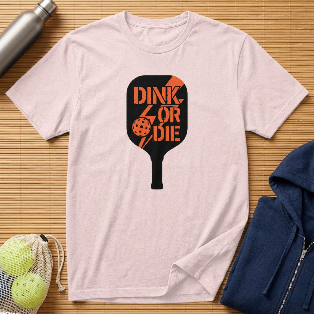 Pink t-shirt with black pickleball paddle graphic reading "DINK OR DIE".