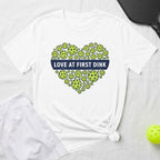 White t-shirt with pickleball heart graphic and "Love at First Dink" text.