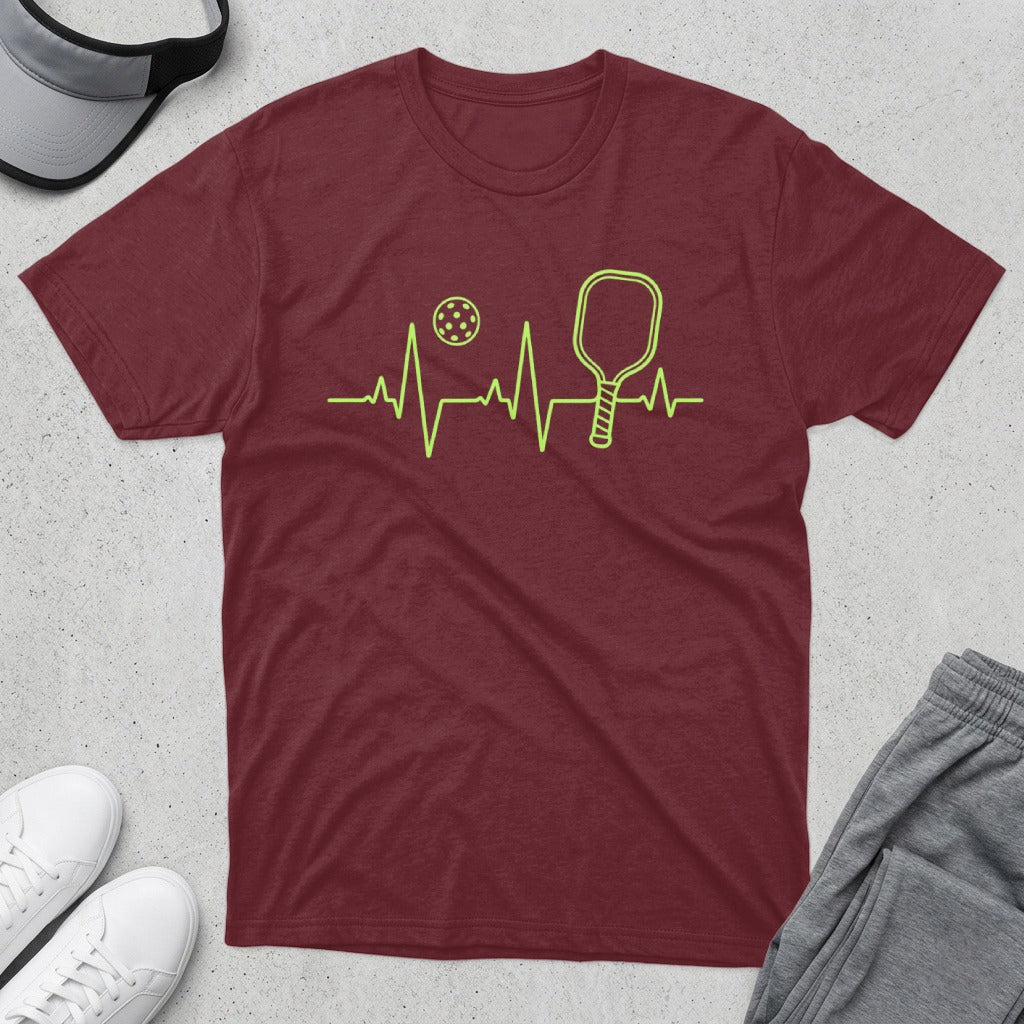 Maroon t-shirt with pickleball paddle, ball, and heart monitor graphic.