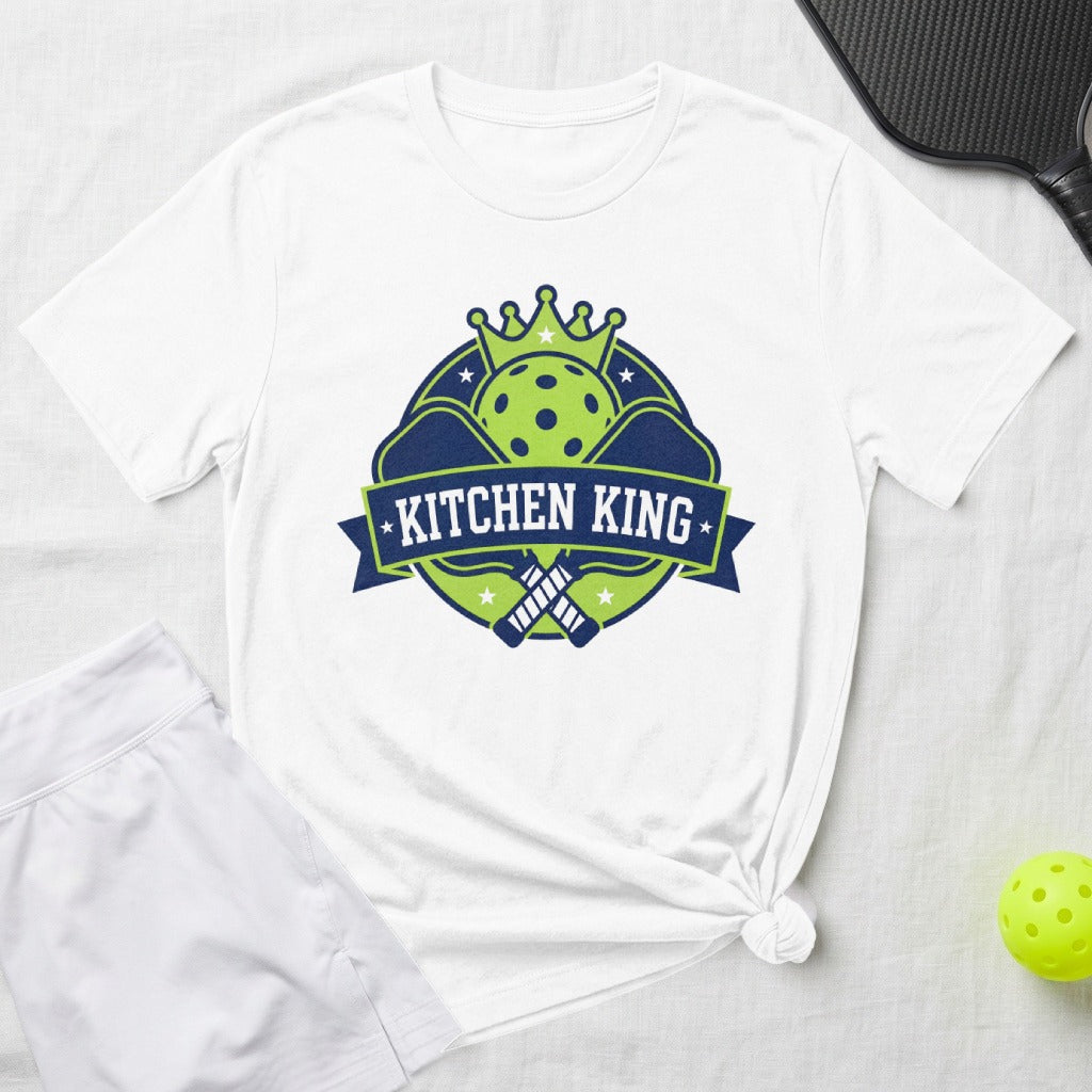White t-shirt with "Kitchen King" logo featuring pickleball paddles and crown.
