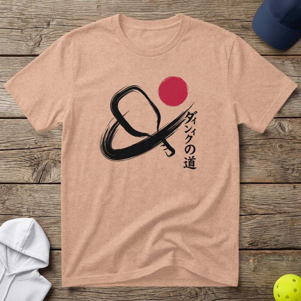 Peach t-shirt with a black pickleball paddle and red circle design, with Japanese text.