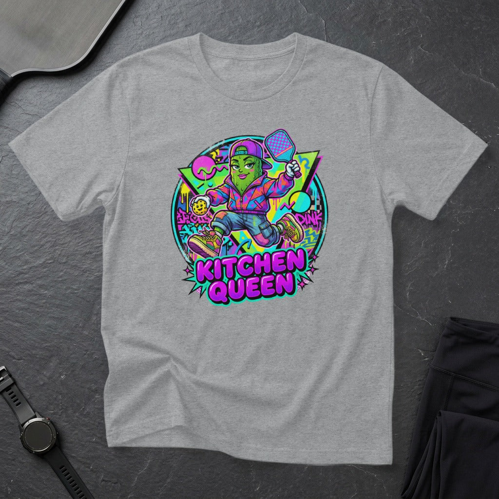 Graphic tee with cartoon pickleball player, "KITCHEN QUEEN" text, bright colors.
