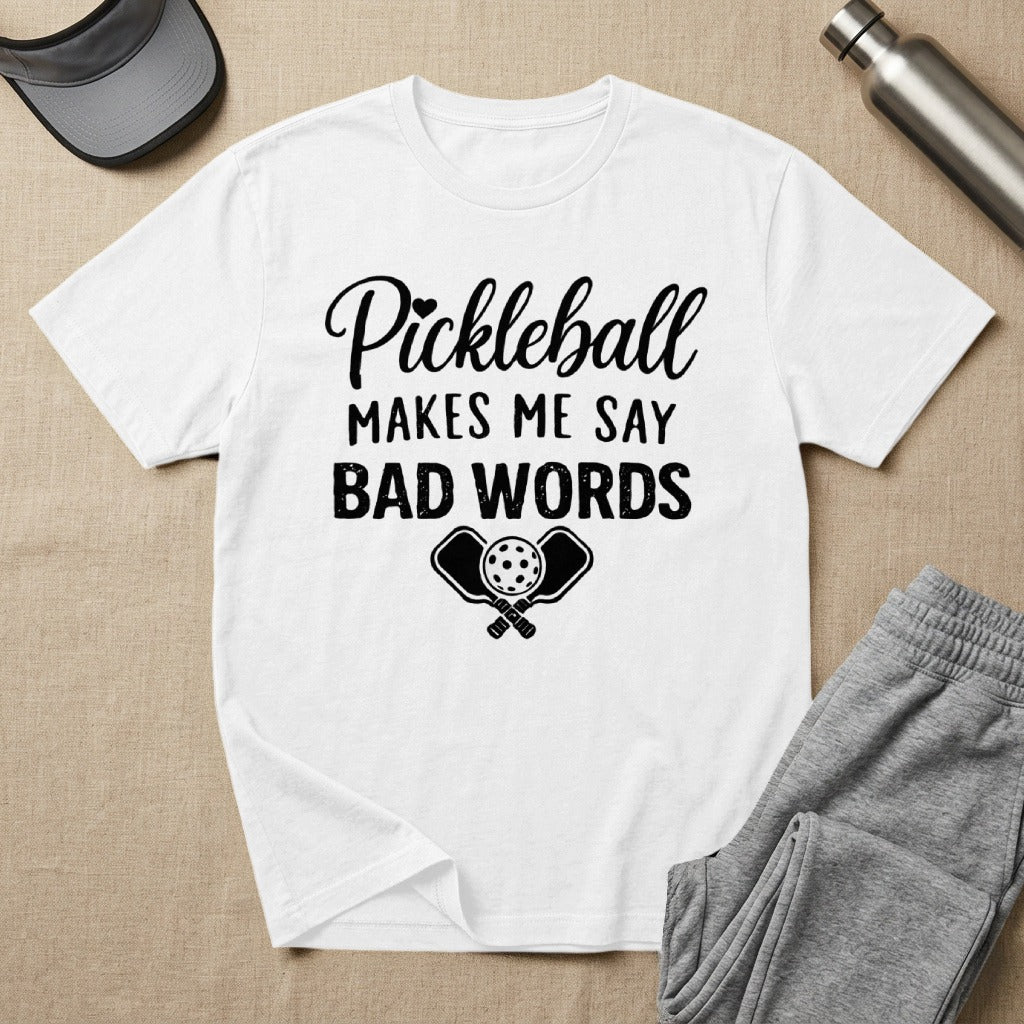 White t-shirt with "Pickleball Makes Me Say Bad Words" and crossed paddles.